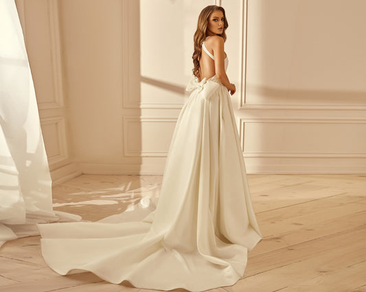 Classic wedding dress with open back, long train and detachable bow. 
Perfect for minimalistic bride.